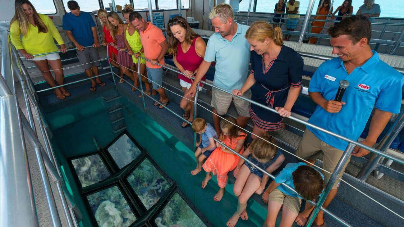 Glass bottom boat tour in Key West, Florida showcasing coral reefs and tropical marine life beneath clear waters.