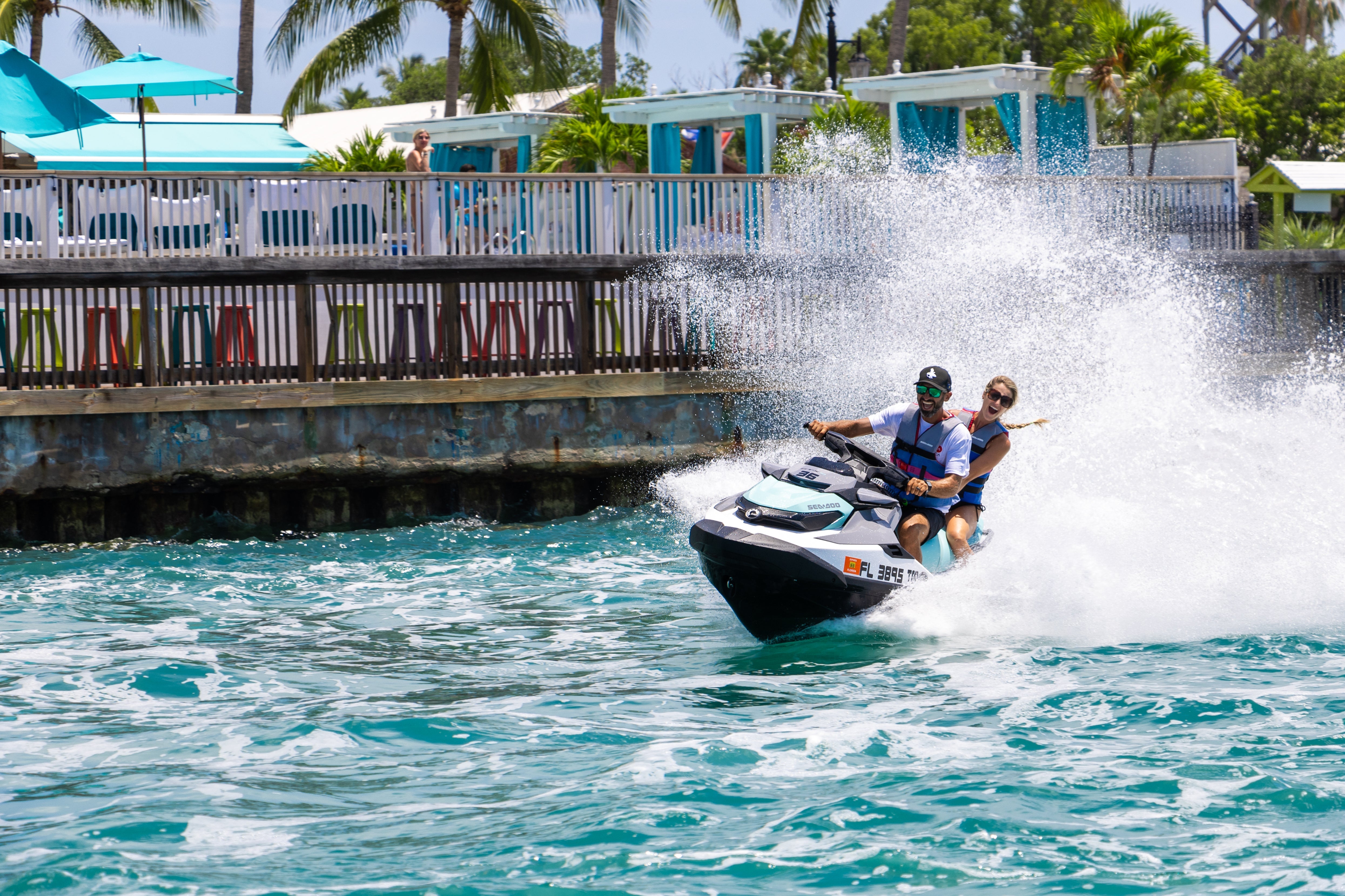 Guided jet ski tour in Key West with riders speeding across turquoise waters and scenic island views.